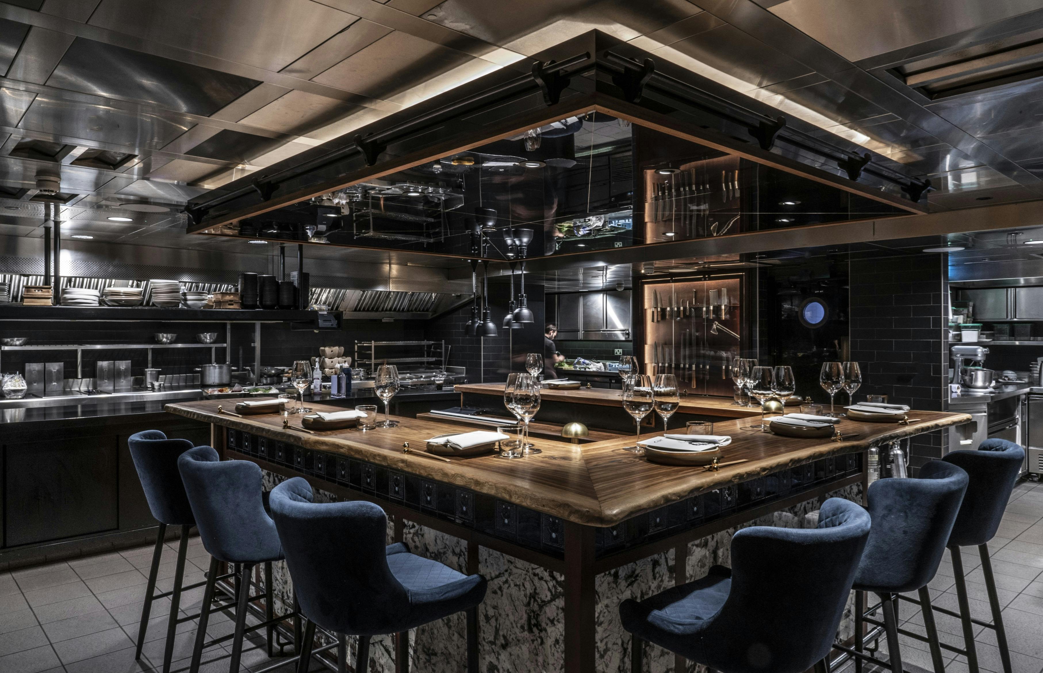 Kitchen table at Lucky Cat by Gordon Ramsay, modern design for upscale dining events.