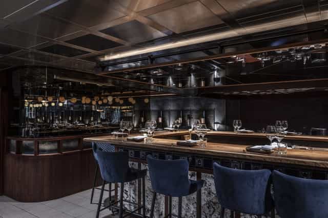 Sophisticated kitchen table in Lucky Cat by Gordon Ramsay for elegant dining events.
