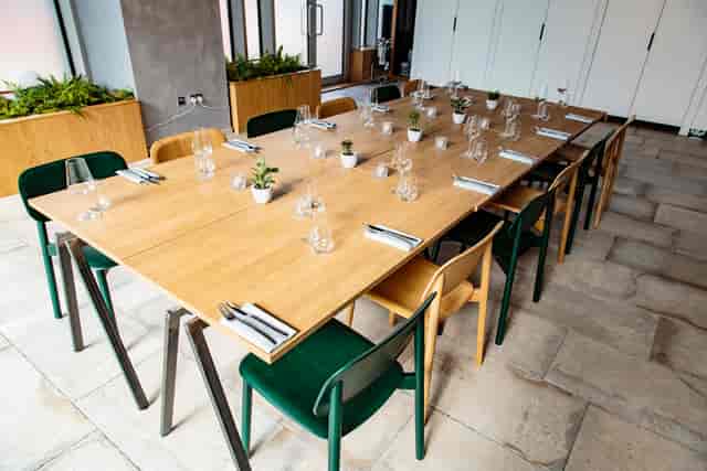 "Elegant meeting space with wooden table, ideal for networking events and discussions."