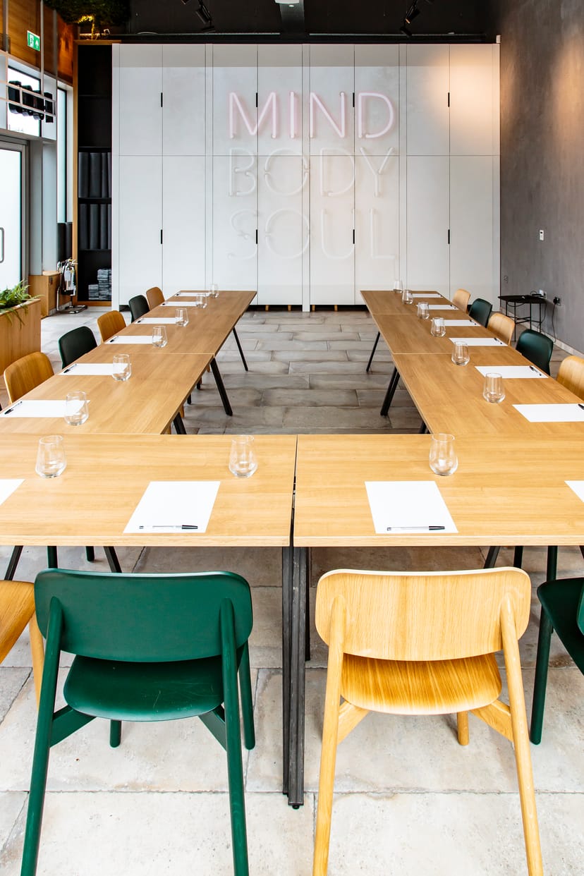 "Professional meeting space with long table, notepads for collaboration events"