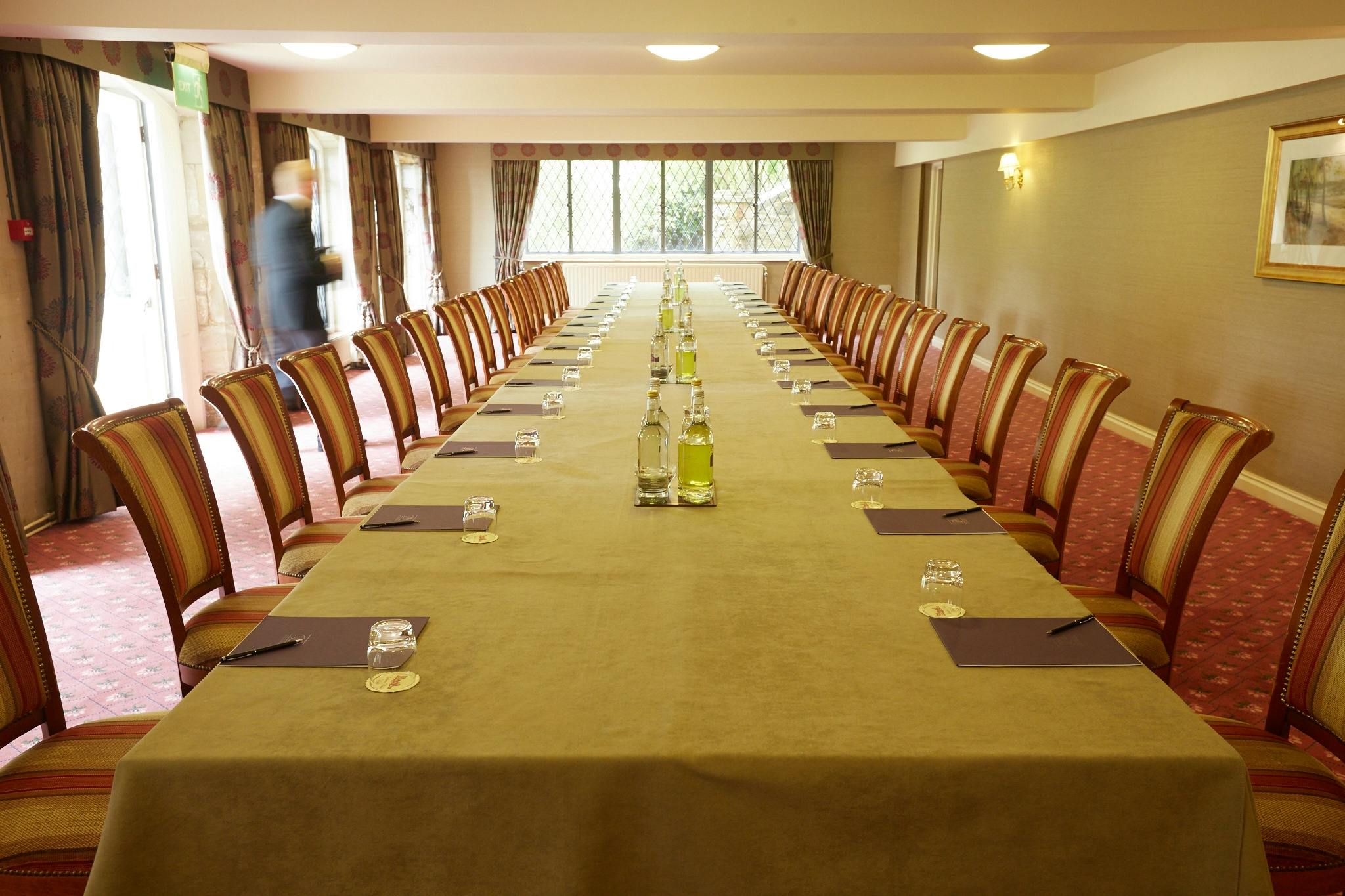 Meeting room setup at Ashdown Park Hotel with natural light for professional gatherings.