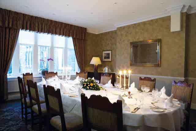 Elegant dining room at Ashdown Park, perfect for intimate meetings and special events.