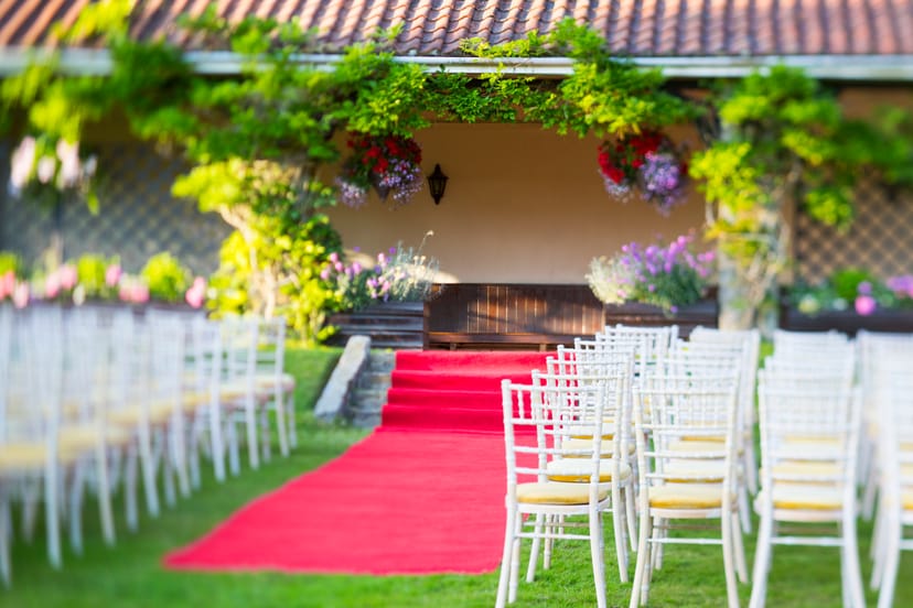 Summerhouse at Ashdown Park: elegant outdoor wedding venue with red carpet and lush greenery.