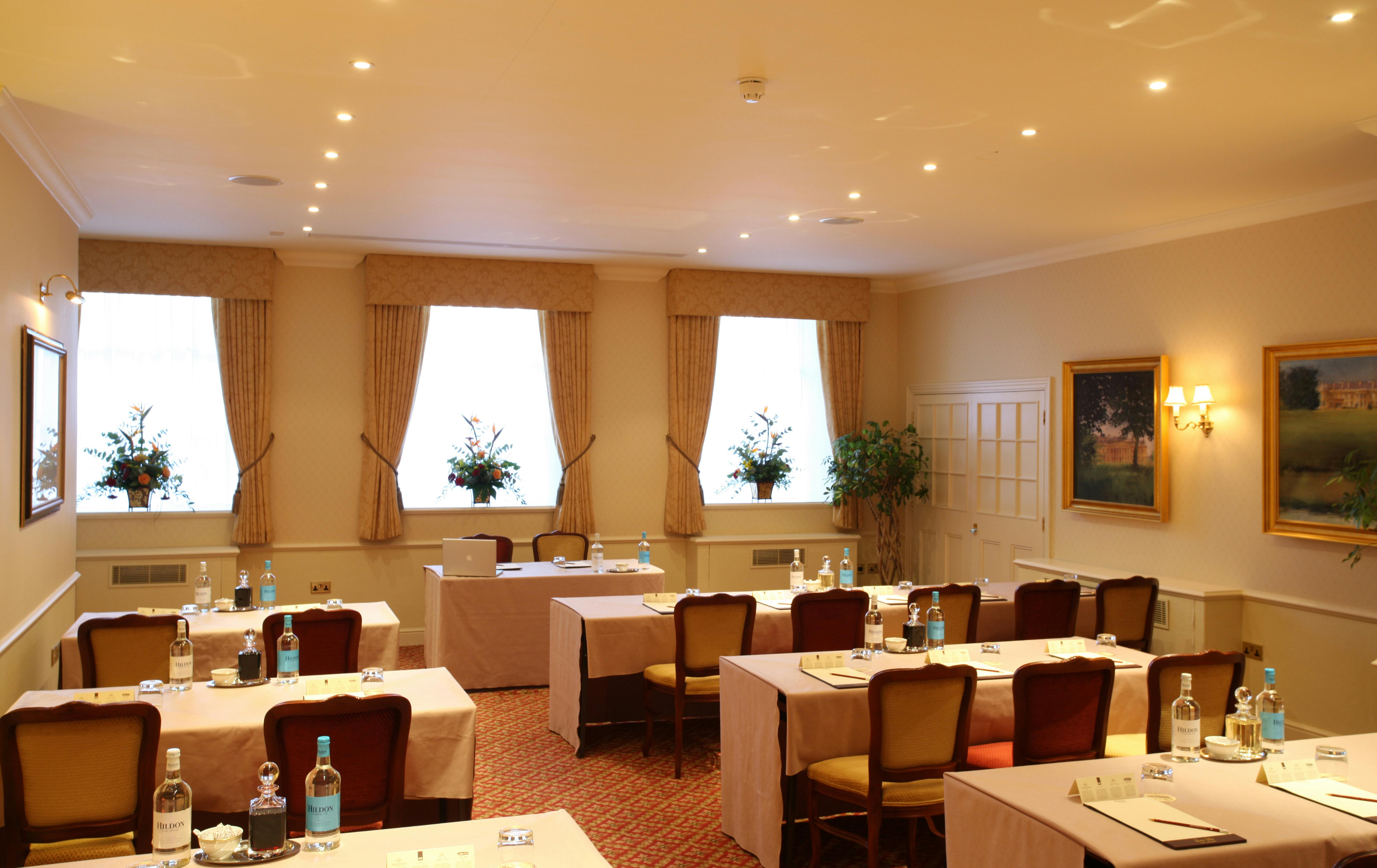 Philip Tilden in elegant meeting room at Luton Hoo Hotel for professional events.