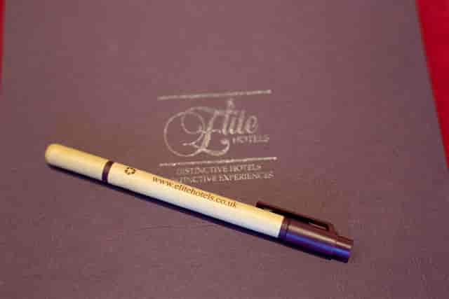 Branded pen on leather notebook at Viscount Castlemaine, ideal for professional events.