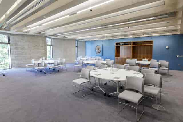 Versatile Carlton Room with round tables, perfect for workshops and small conferences.