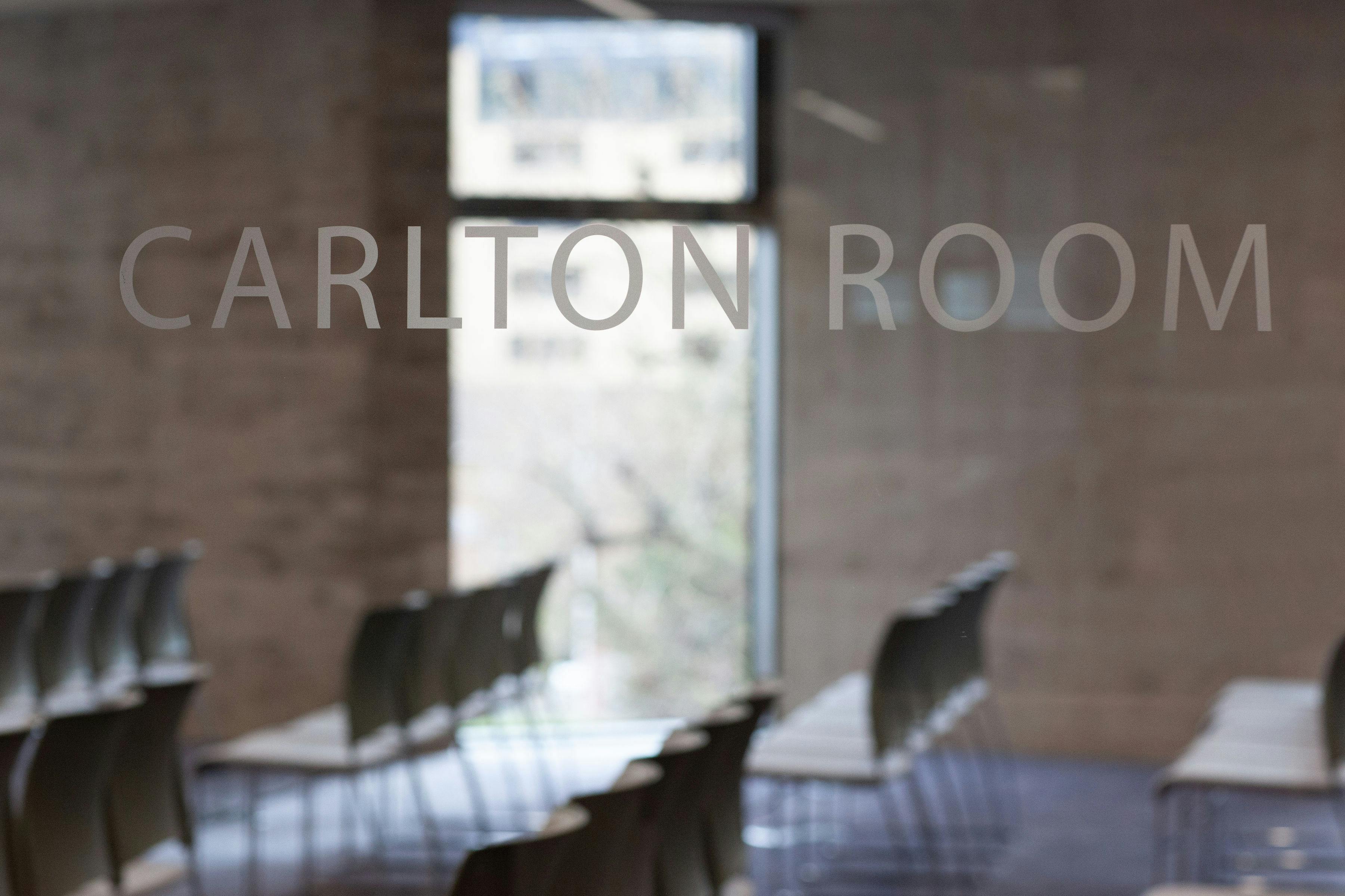 Carlton Room meeting space with minimalist chairs, perfect for workshops and presentations.