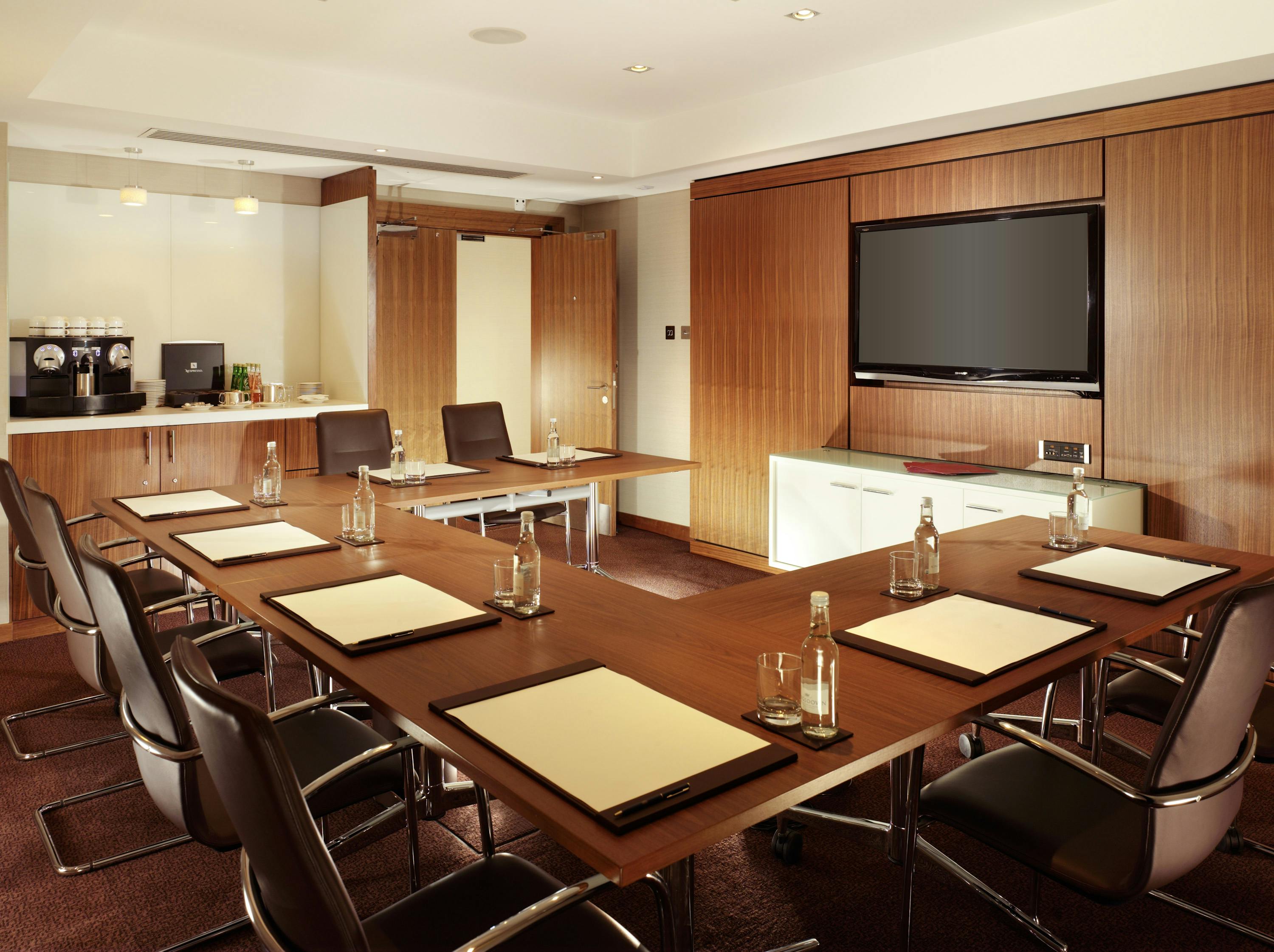 Chelsea Executive Boardroom at Royal Garden Hotel, modern decor for meetings and presentations.