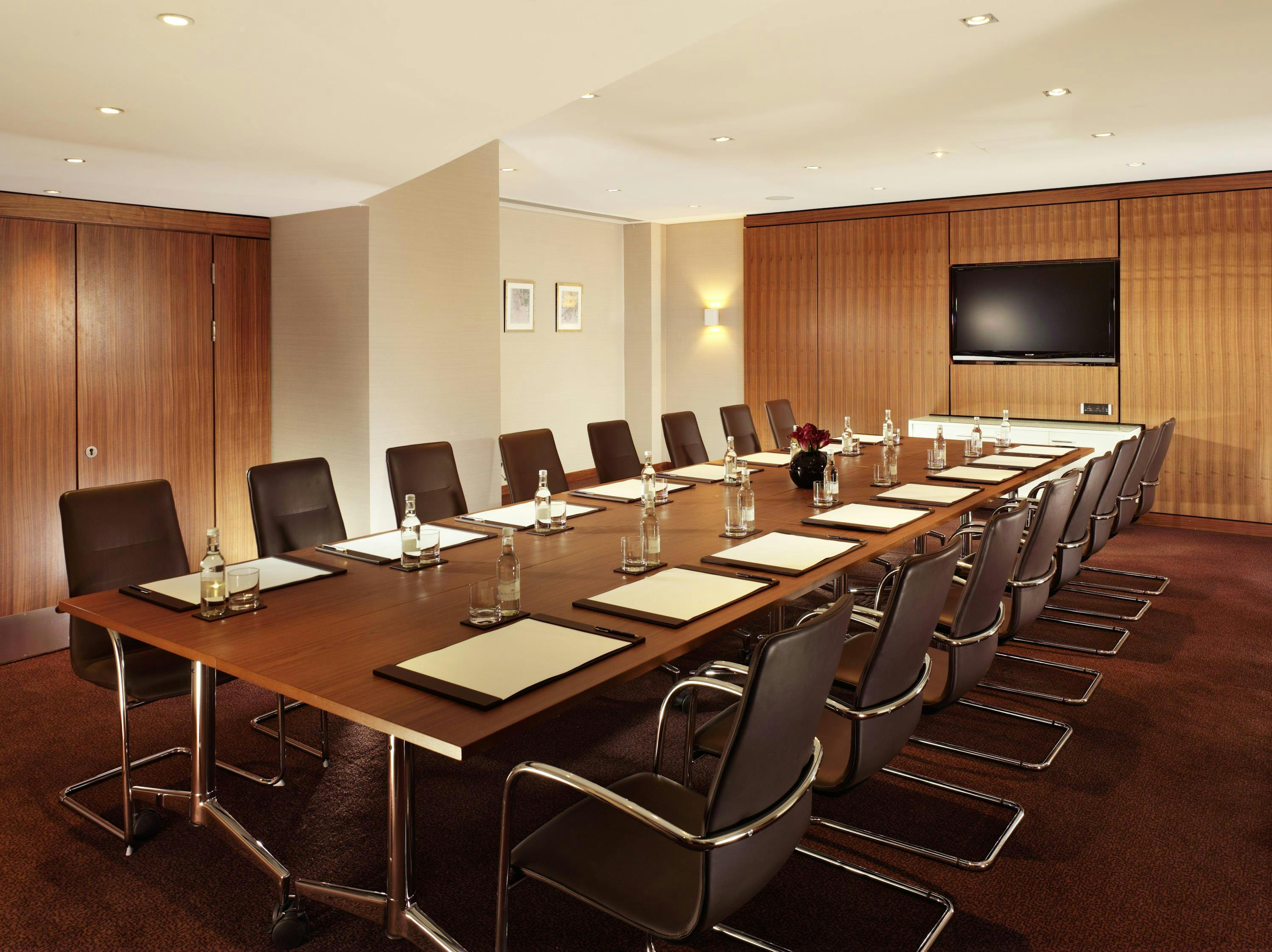 Westminster Executive Boardroom with wooden table, ideal for corporate meetings and presentations.