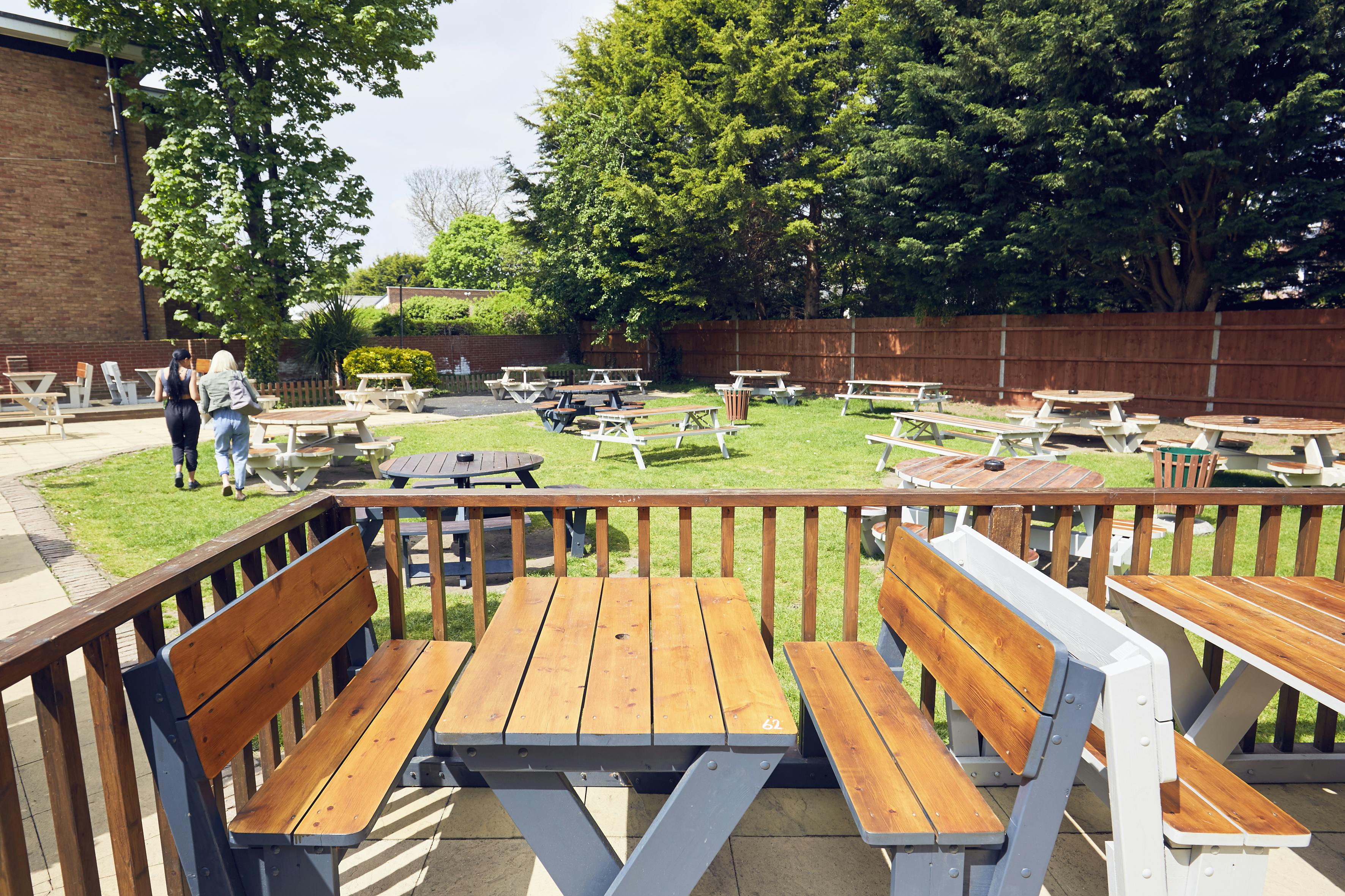 Outdoor event space with picnic tables for casual gatherings at The Royal Oak.