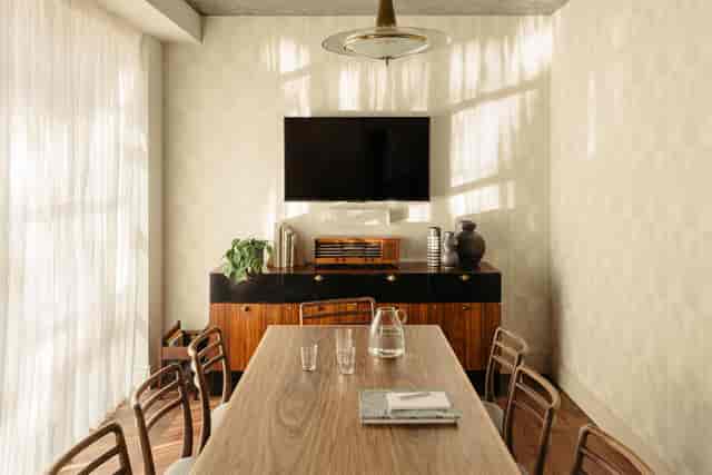 Modern meeting room in The Hoxton Southwark with wooden table, ideal for events.