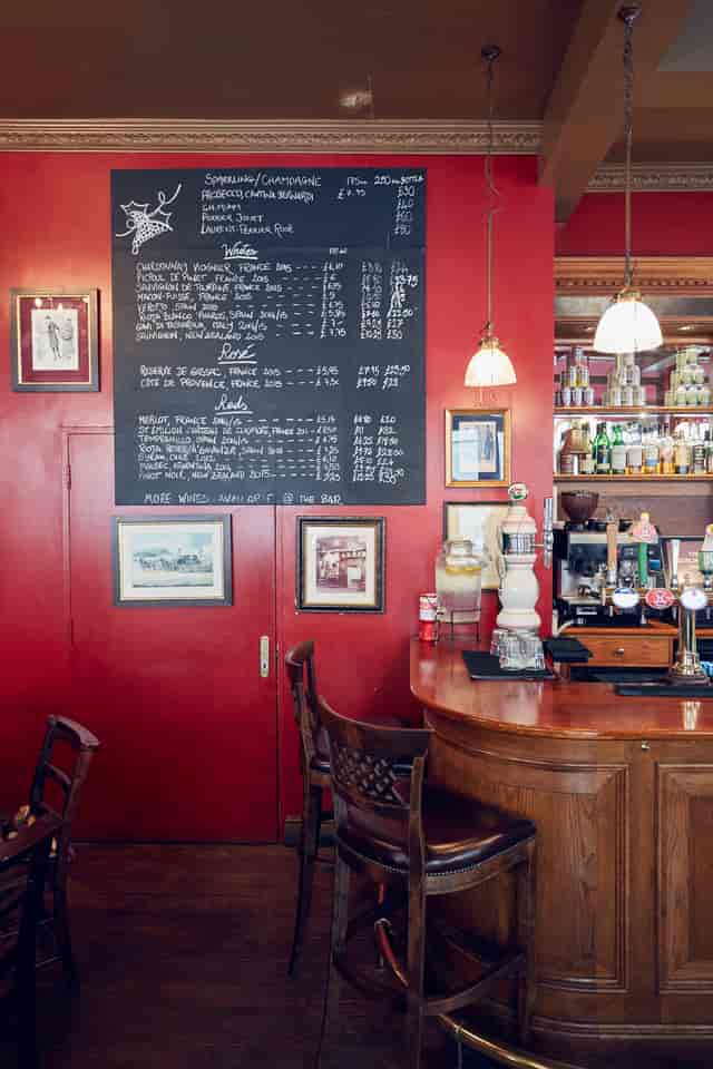 Cozy bar at Burlington Arms with chalkboard menu, perfect for networking events.