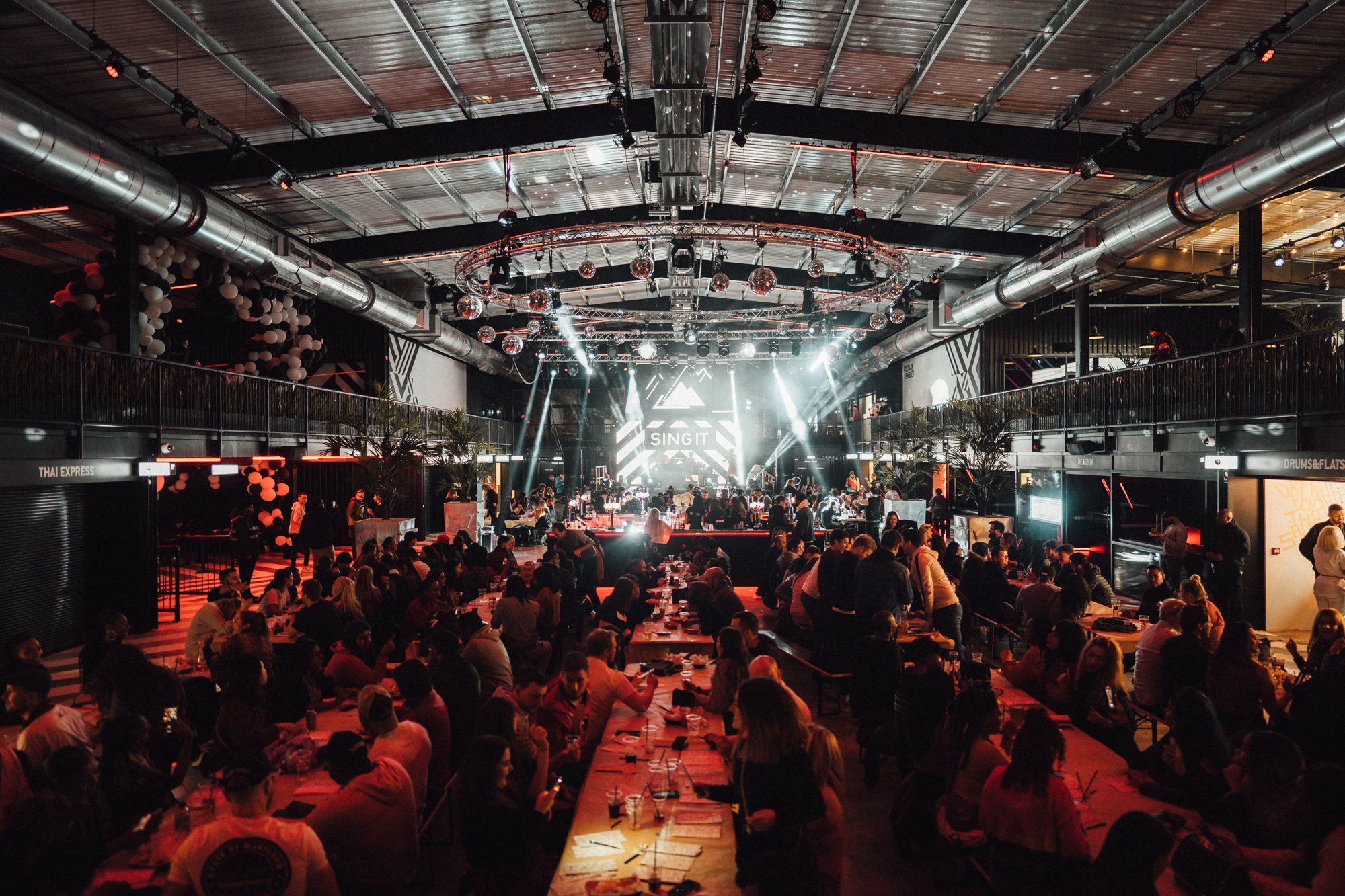 Vibrant Venue Takeover at Boxpark Wembley with high ceilings for conferences and gala dinners. - Banner