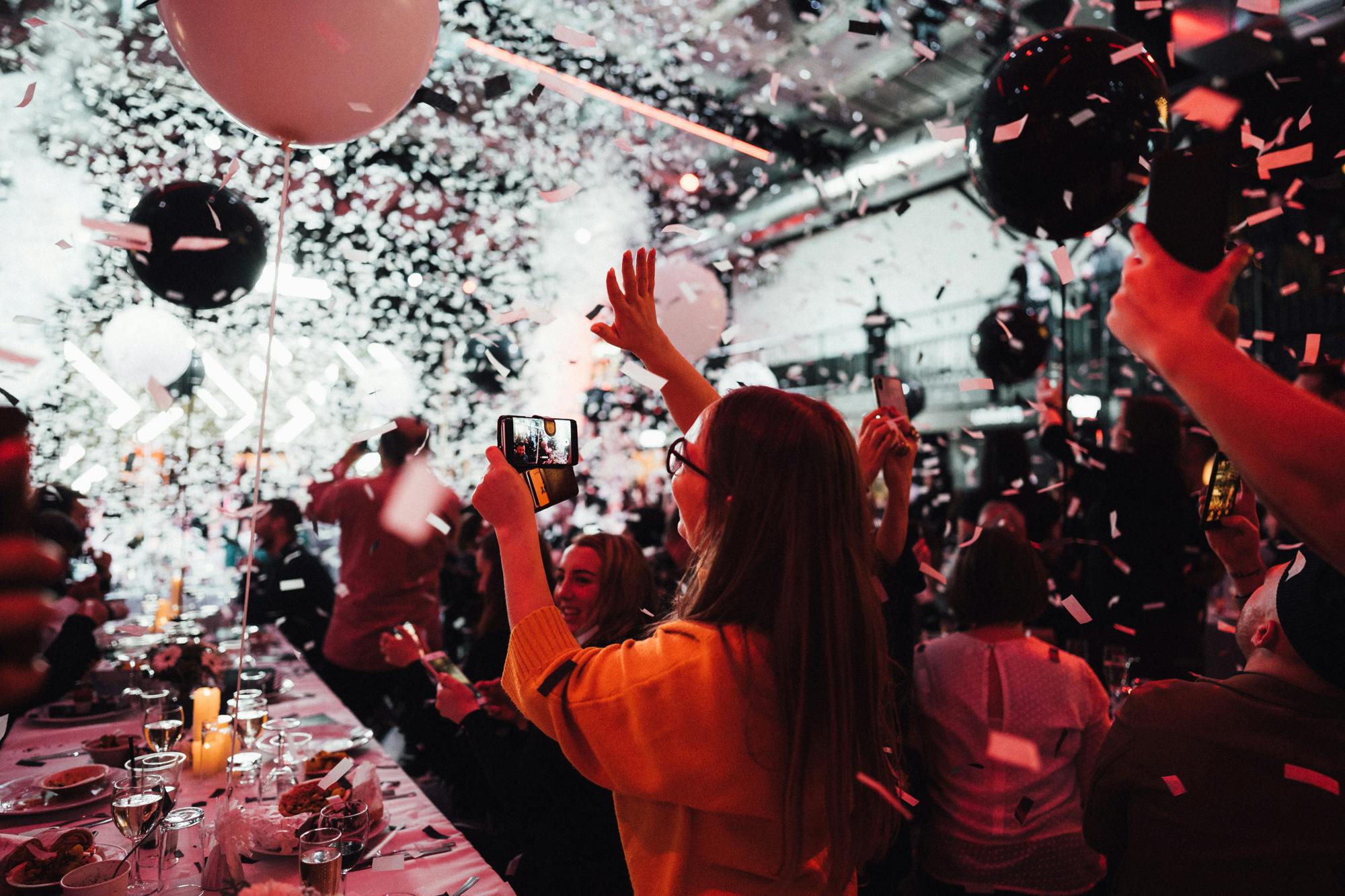 Vibrant Venue Takeover event at Boxpark Wembley with confetti and balloons.