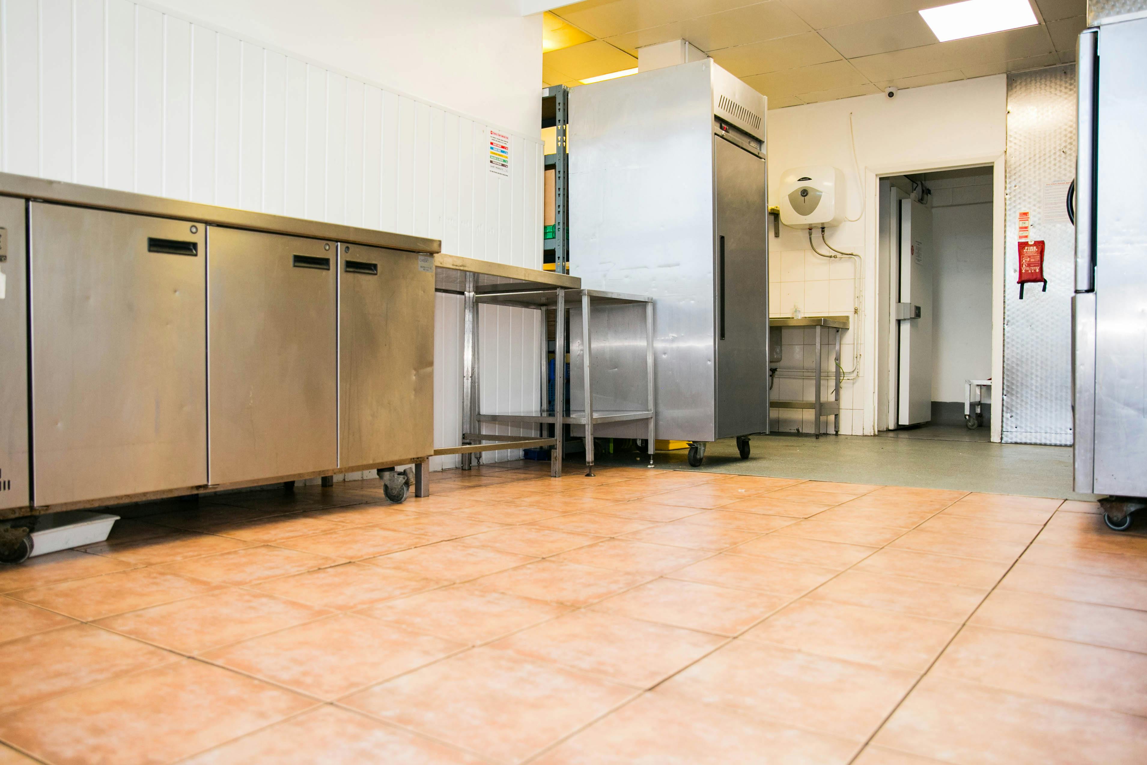 Commercial kitchen at The Olive Grows Ltd with stainless steel appliances for event catering.