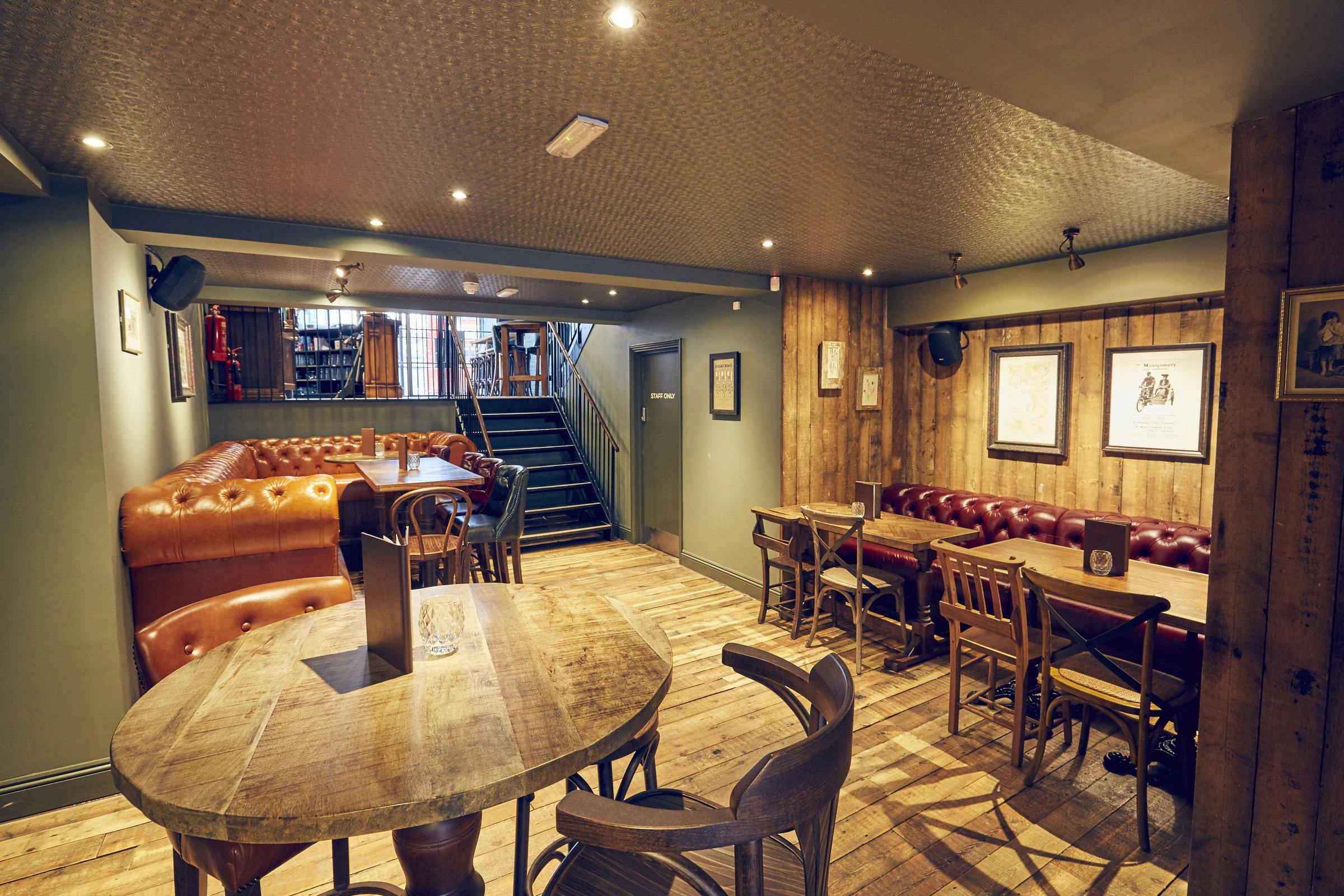 Cozy East Putney Tavern downstairs area with leather couches for informal meetings and gatherings.