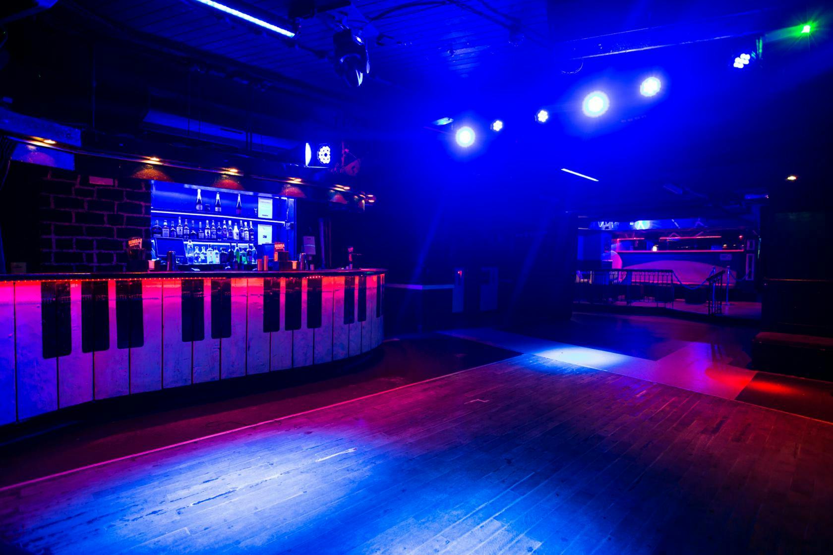 Vibrant Dance Bar at Bar Rumba with piano key design, perfect for nightlife events.