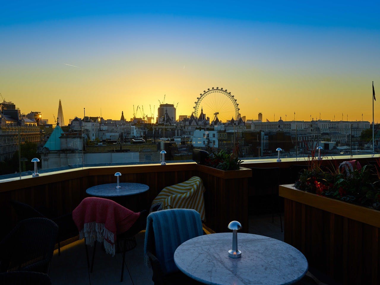 Stunning rooftop venue at Trafalgar St James with sunset skyline, ideal for cocktail receptions.