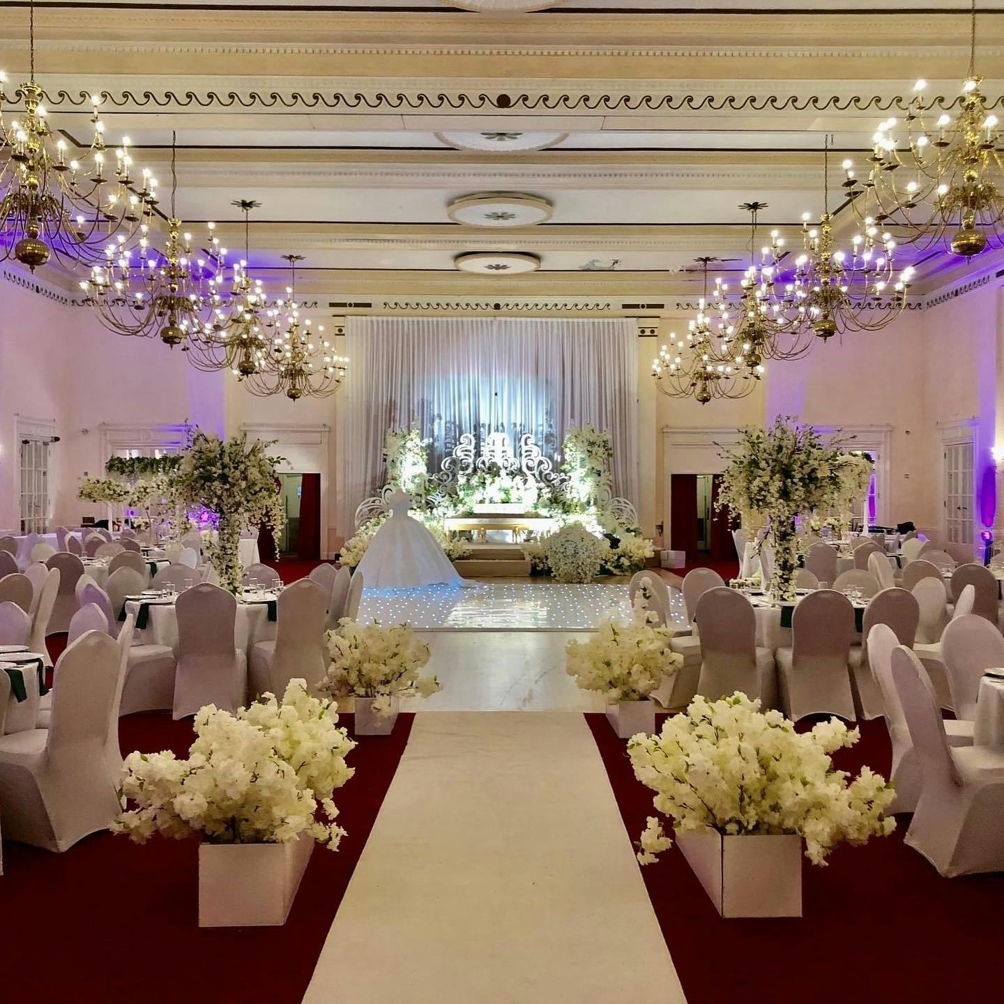 Elegant wedding venue in The Adelphi Hotel's Banqueting Hall with floral centerpieces.