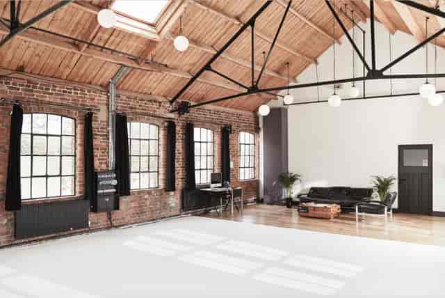 Spacious, well-lit event space with exposed brick for meetings and workshops.