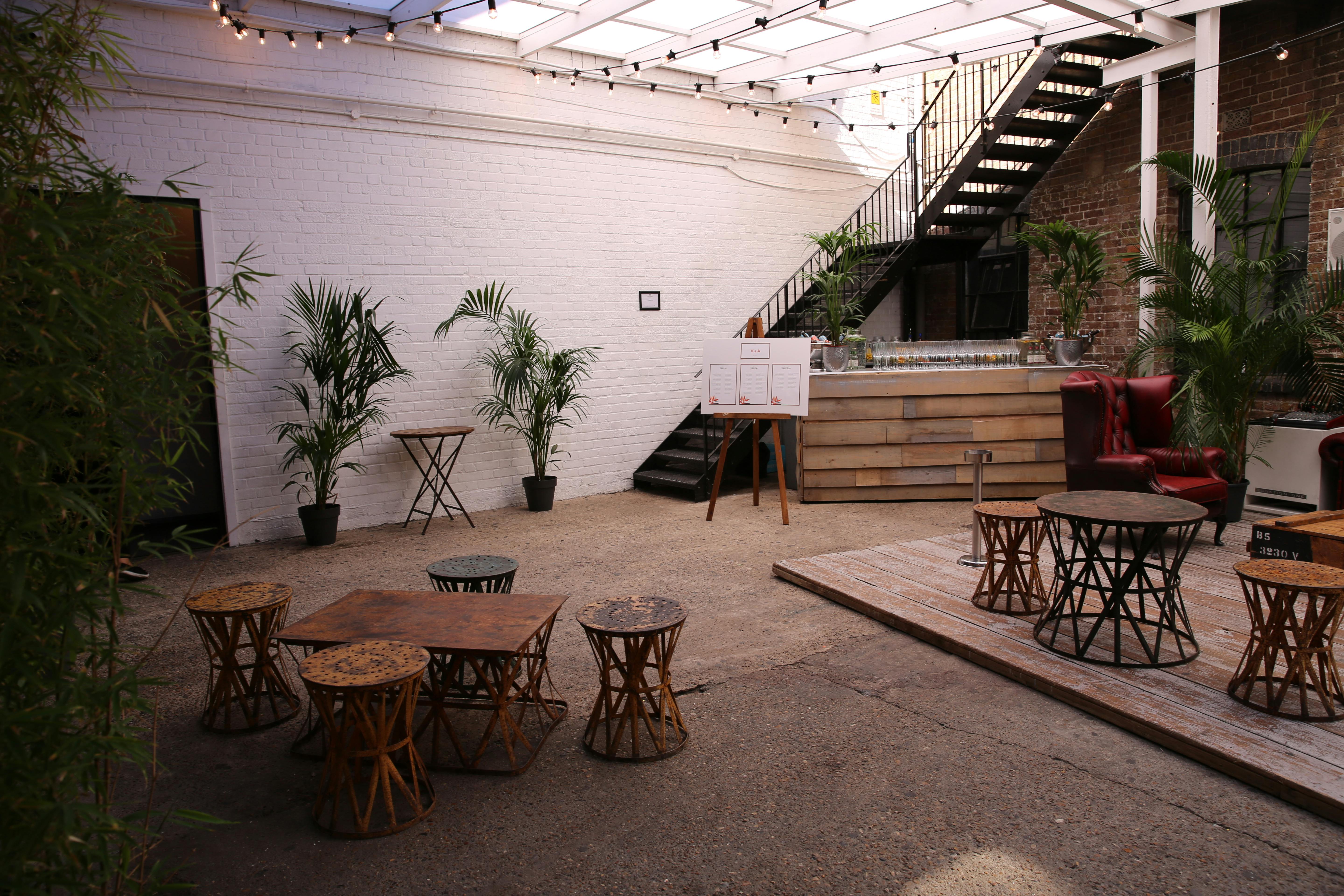Daylight Courtyard at Loft Studios: versatile event space with greenery and warm lighting.