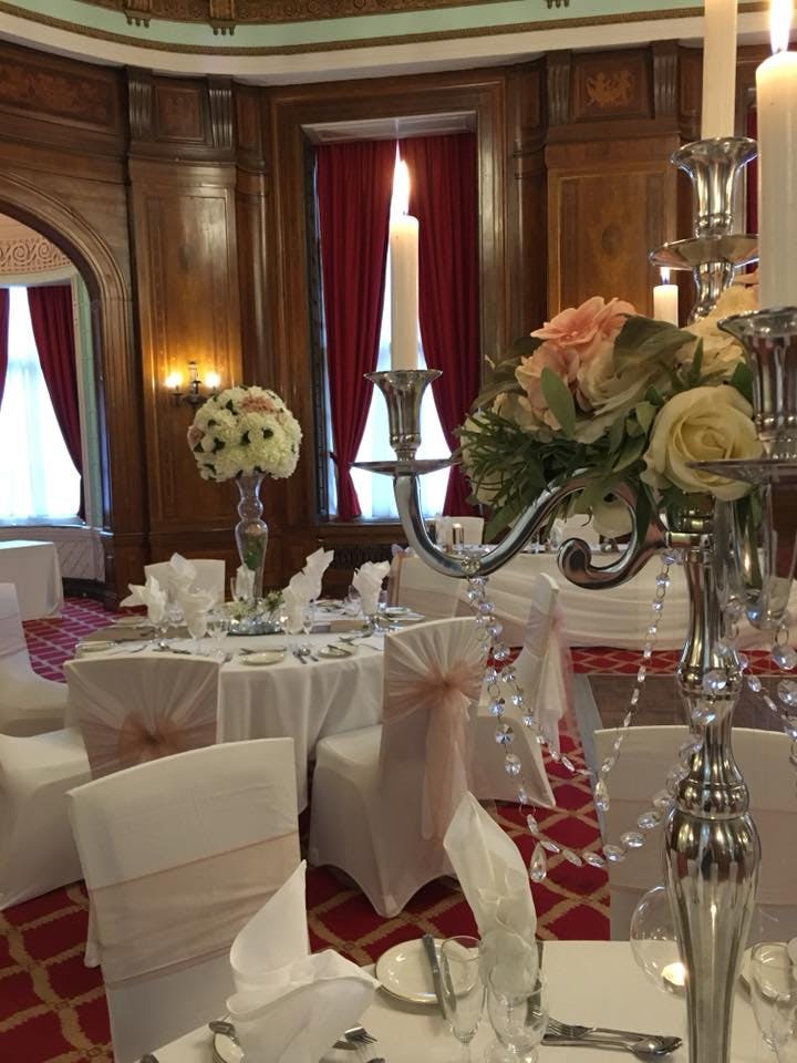 Elegant Sefton Suite banquet room with floral centerpieces, perfect for weddings and upscale events.