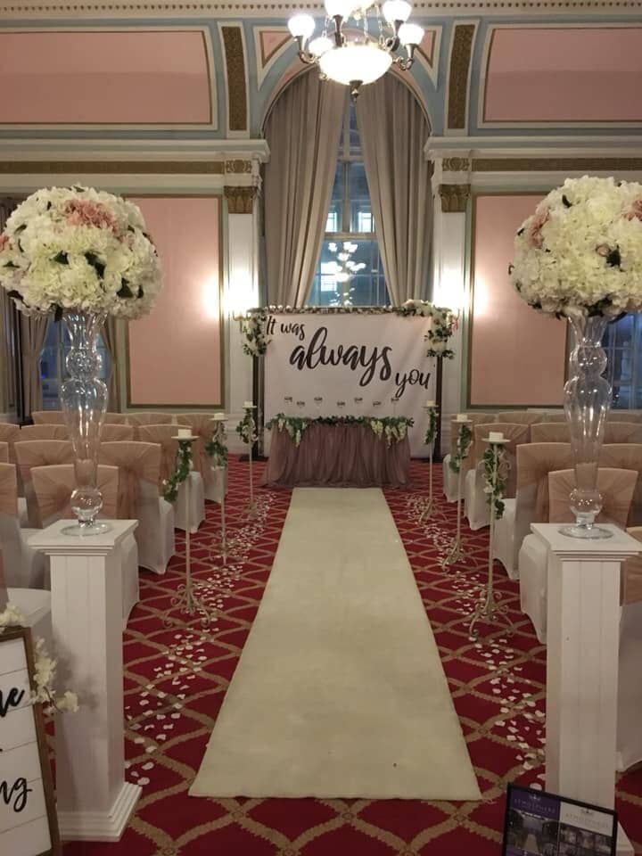 Crosby Suite at The Adelphi Hotel, elegant wedding setup with floral decor and plush aisle.