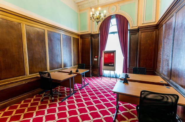 Elegant meeting room with wood paneling at The Adelphi Hotel for corporate events.