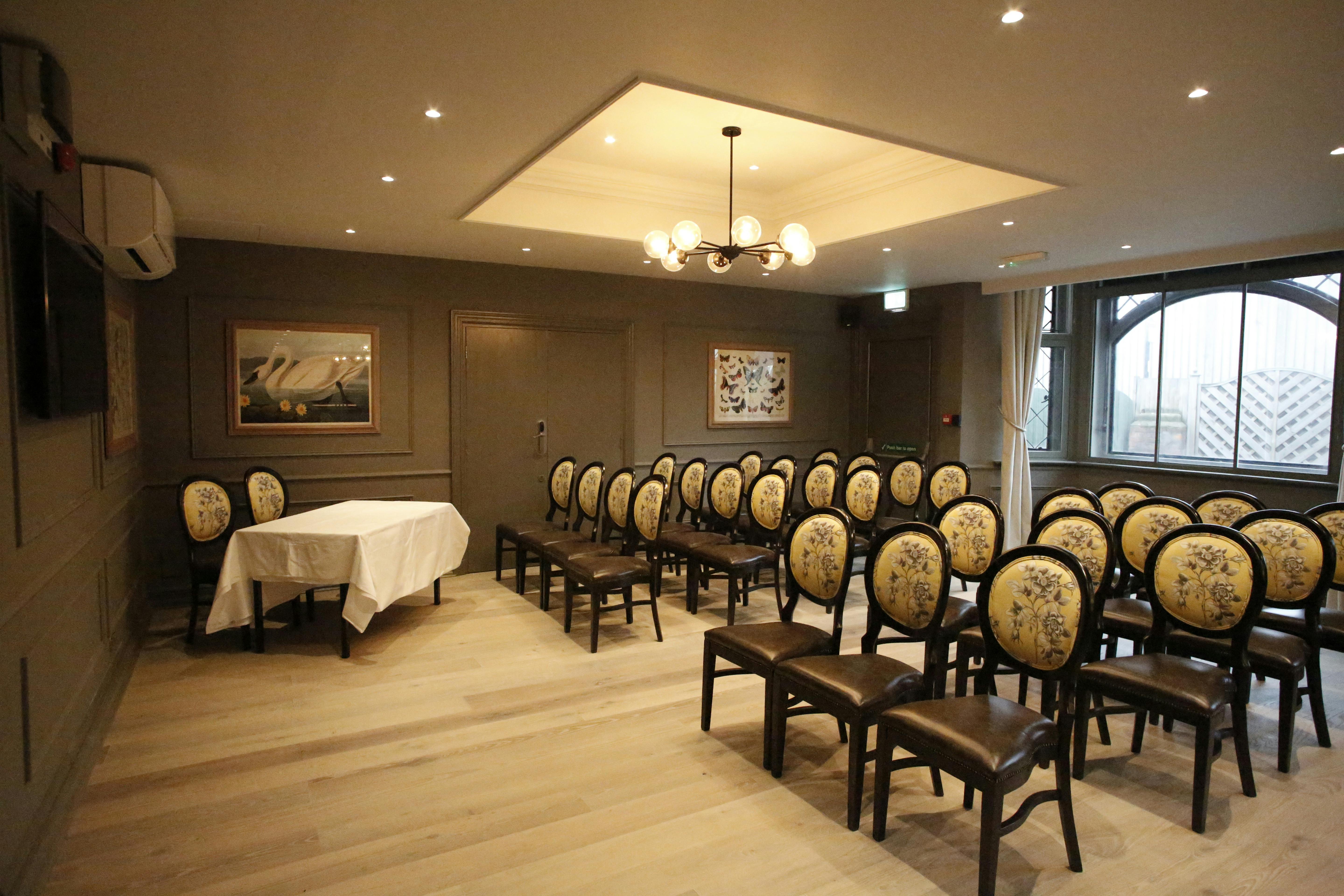 Waterloo Suite meeting room with floral chairs, ideal for workshops and conferences.