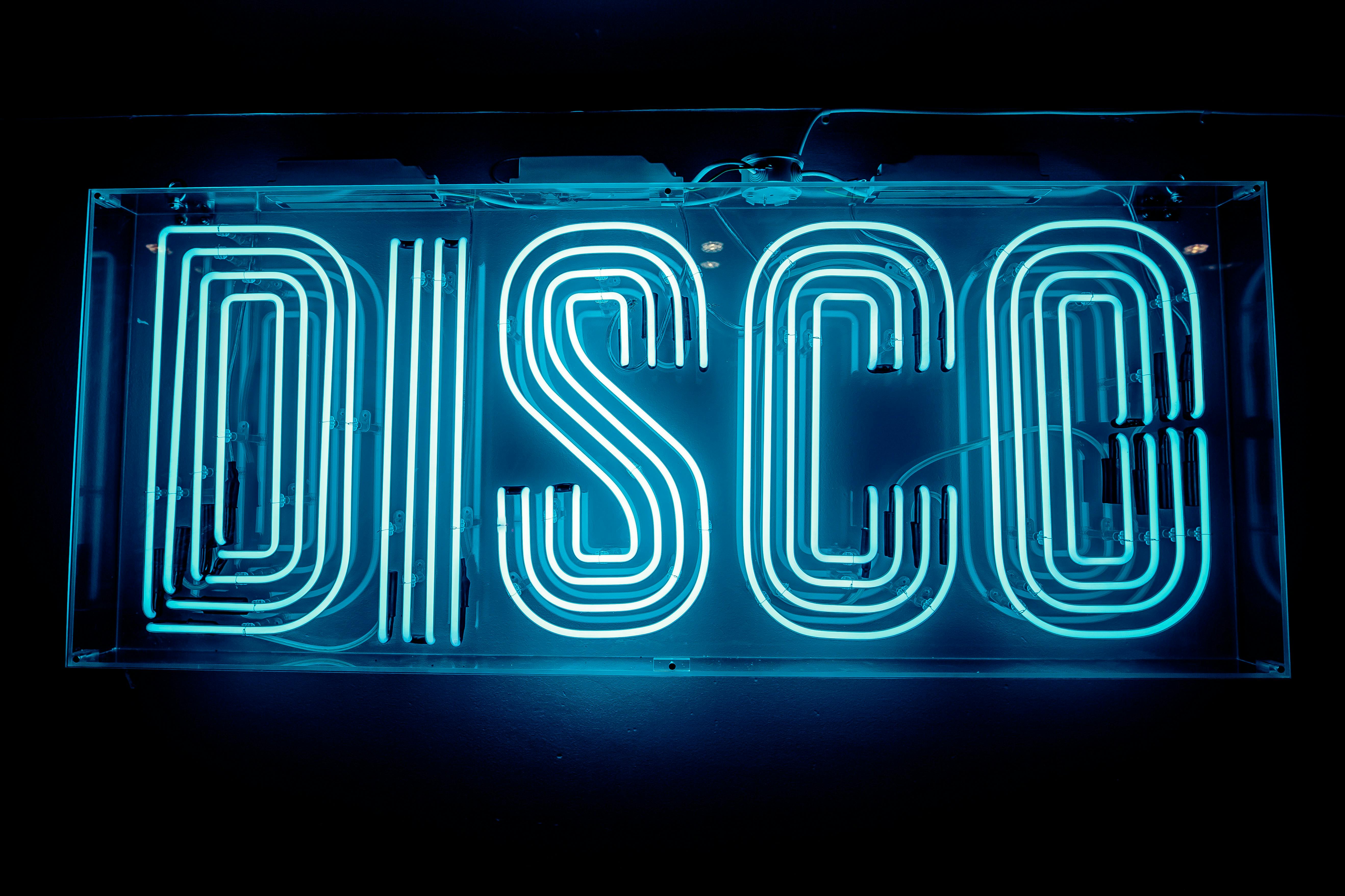 Vibrant neon "DISCO" sign at Simmons Oxford Street for lively themed events and parties.