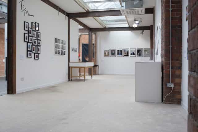 Versatile event space in Iron House with minimalist design for art exhibitions and meetings.