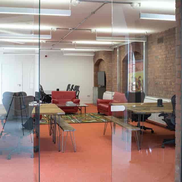 Modern meeting space in Iron House with vibrant colors for collaborative events.