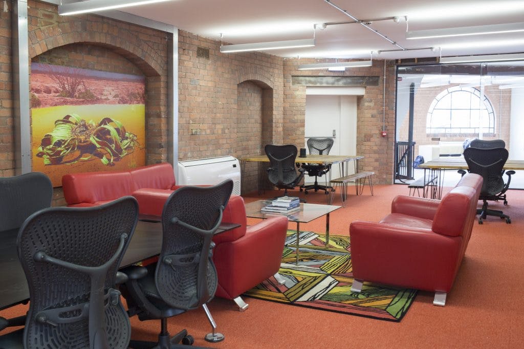 Modern office meeting space with red seating for collaborative brainstorming sessions.
