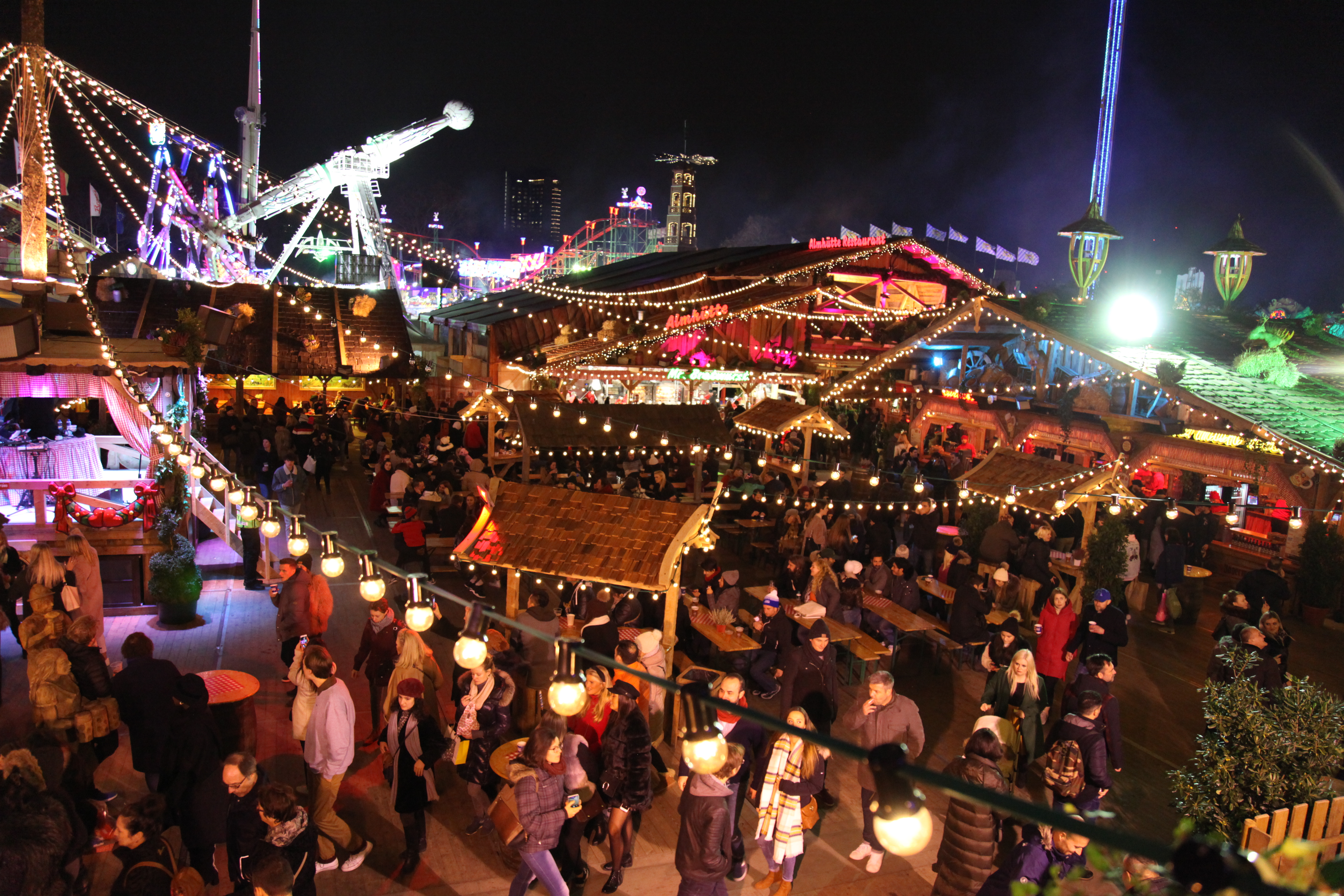 Vibrant outdoor event at Cafe Bavaria with colorful lights and festive decorations. - Banner