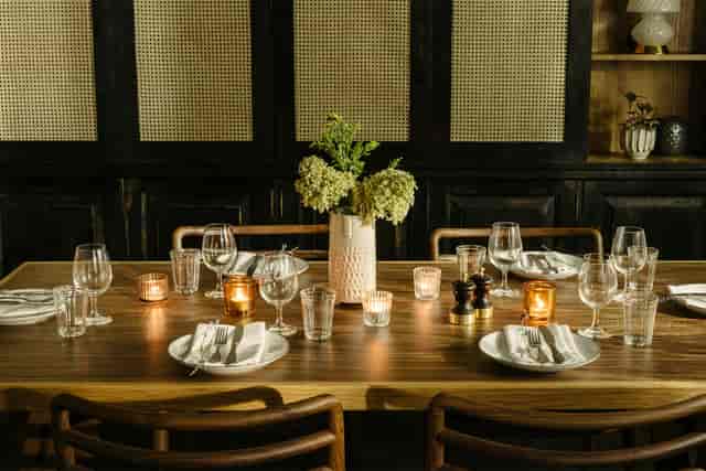 Elegant dining table with floral centerpiece for intimate gatherings and corporate dinners.