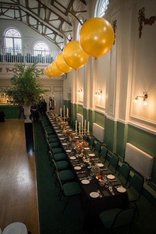 Elegant dining table with floral centerpieces in Hammersmith Club for formal events.