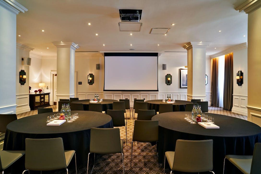 Meeting room at Kimpton Fitzroy London with round tables for professional gatherings.