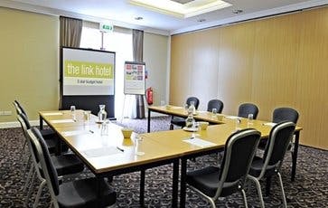 Butler meeting room at The Link Hotel with U-shaped table setup for corporate events.