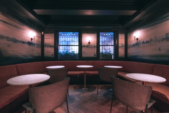 Stylish meeting space 'Le Première' with plush seating, ideal for networking events.