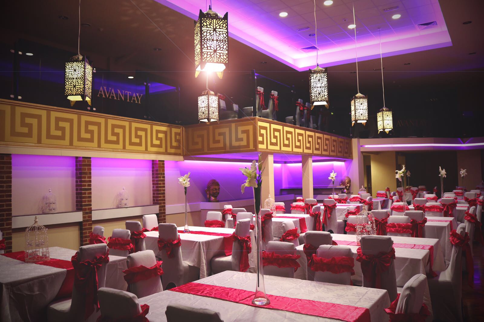 Elegant banqueting suite with white tables and red accents for corporate events or weddings. - Banner