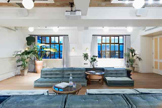 Stylish meeting space with natural light and greenery for collaborative events.