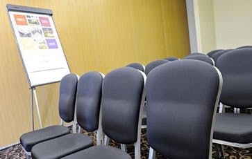 Meeting setup at The Wallace, The Link Hotel with organized chairs and flip chart.