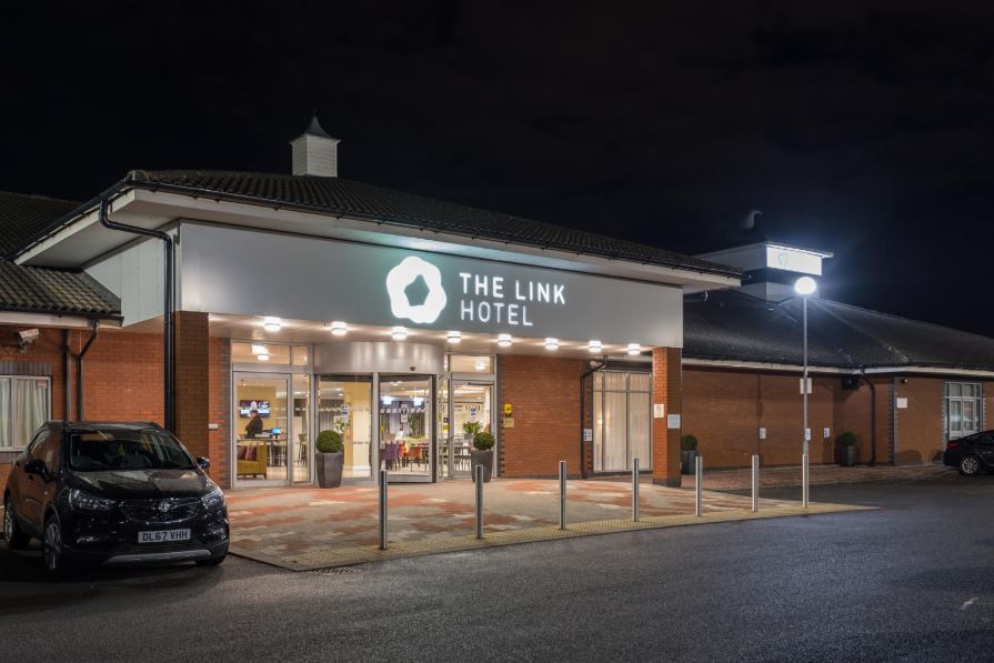 Modern hotel entrance of The Wallace at The Link Hotel, ideal for corporate events. - Banner