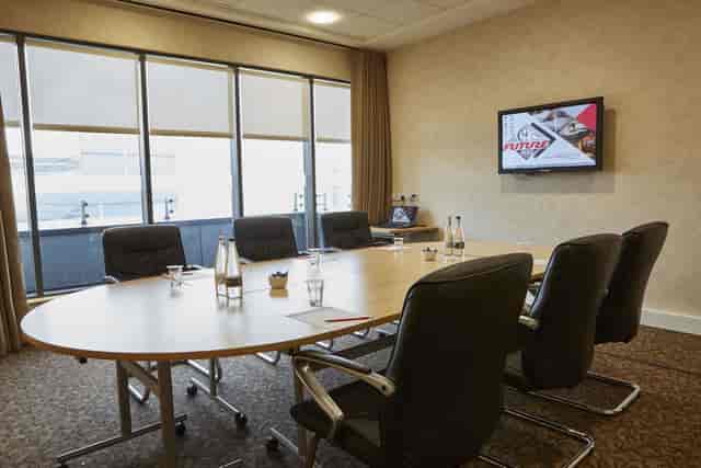 Meeting room with oval table and ergonomic chairs at Future Inn Bristol Hotel.