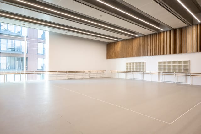 Spacious rehearsal studio with natural light at English National Ballet, ideal for workshops.