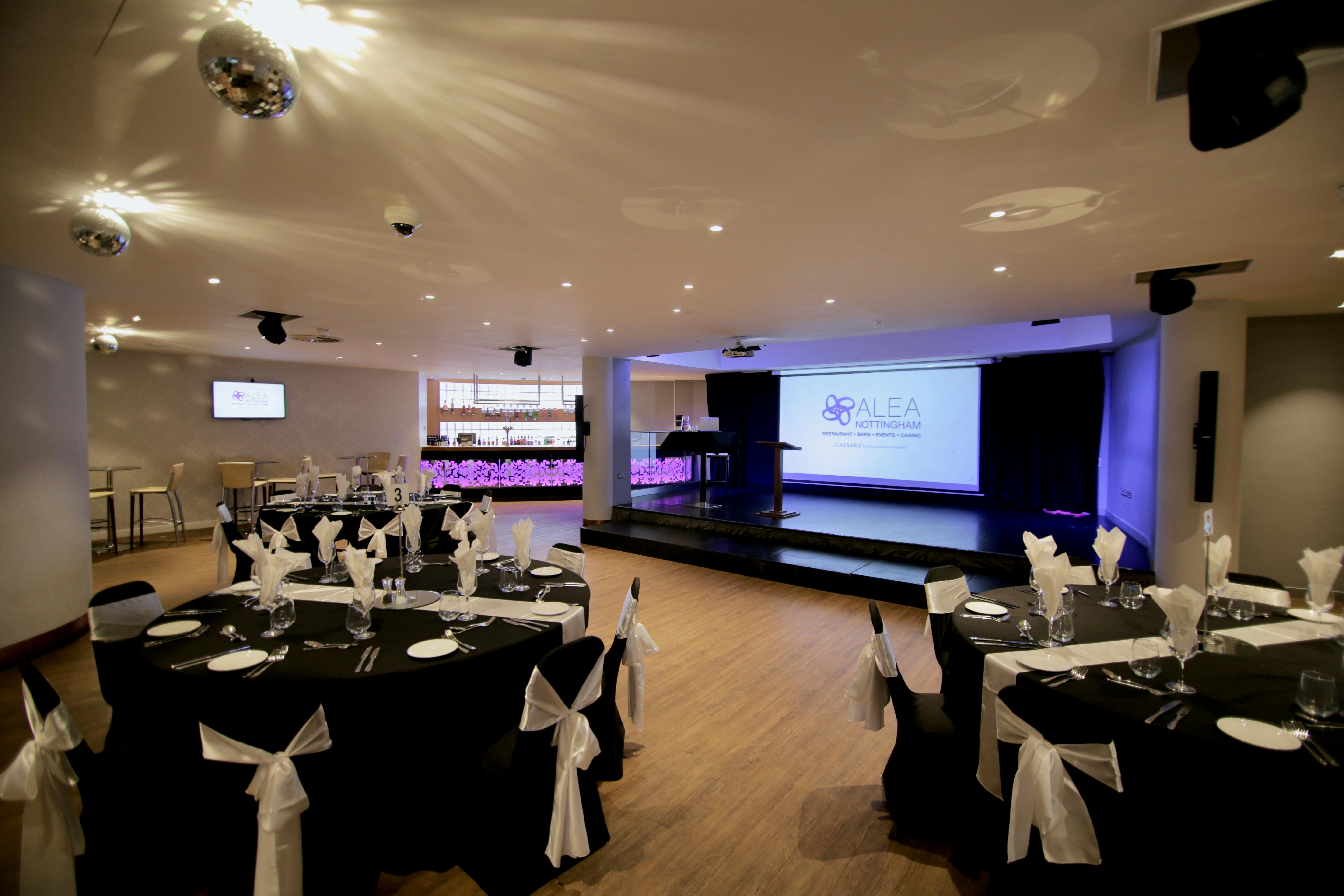 Elegant event space at Alea Casino with round tables, ideal for conferences and celebrations.