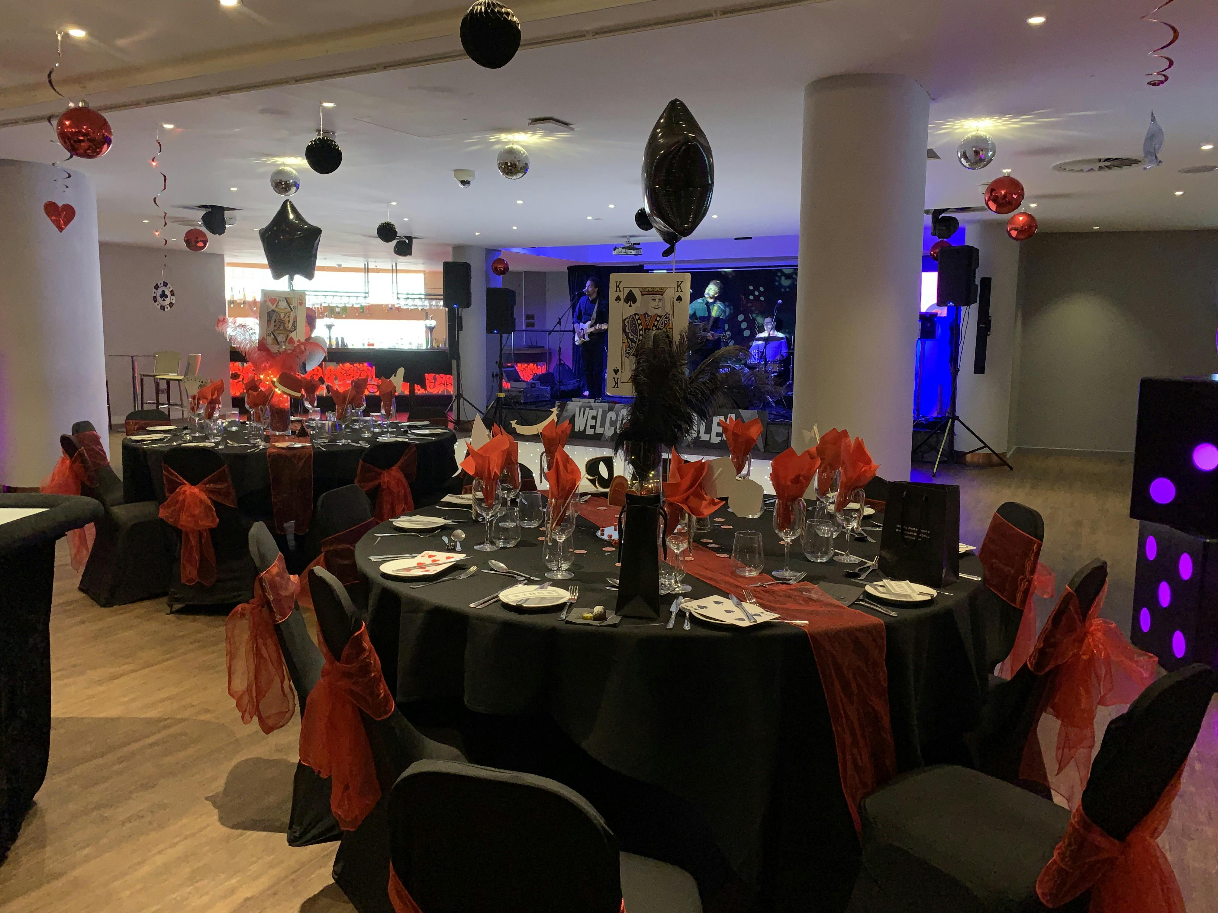 Elegant event space at Alea Casino with black and red decor for formal gatherings.