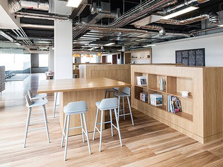 Modern open-concept workspace with warm wood tones for collaboration and meetings.