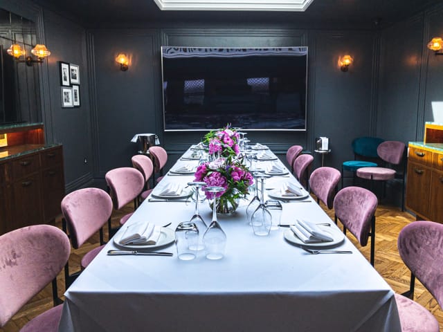 Elegant meeting space with floral centerpiece for corporate events and private dinners.