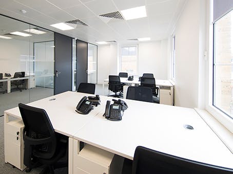 Modern minimalist office space with natural light for productive meetings and collaboration.
